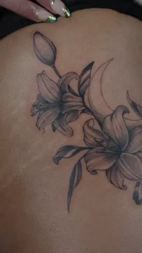 Black and grey lilies and crescent moon tattoo by Maiku — WA Tattoo Las Vegas