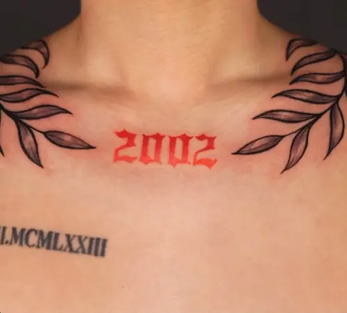 Red gothic lettering and laurel collarbone tattoo by Maiku — WA Tattoo Las Vegas
