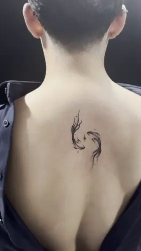 Ink-wash koi pair upper-back tattoo by Vina — WA Tattoo Las Vegas